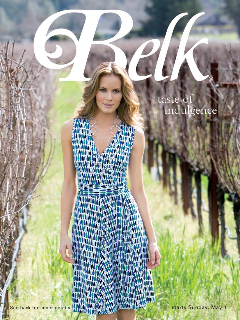 Belk Taste of Indulgence catalog cover featuring a model in a patterned dress between vineyard rows