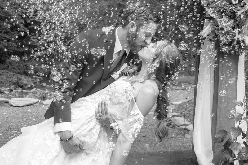 A newly married couple celebrating amid floating bubbles